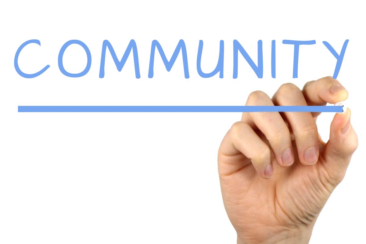 Decorative image of the word COMMUNITY being written and underlined.